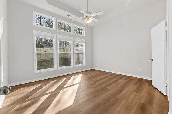 a view of an empty room with wooden floor