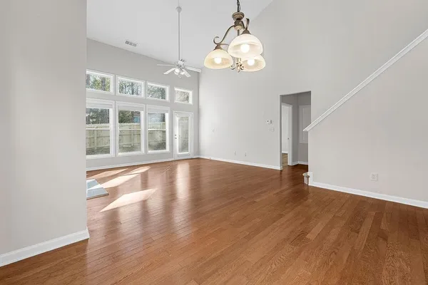 a view of a kitchen with wooden floor and a ceiling fan