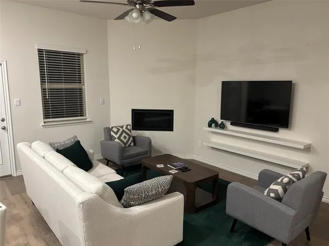 a living room with couches and a flat screen tv