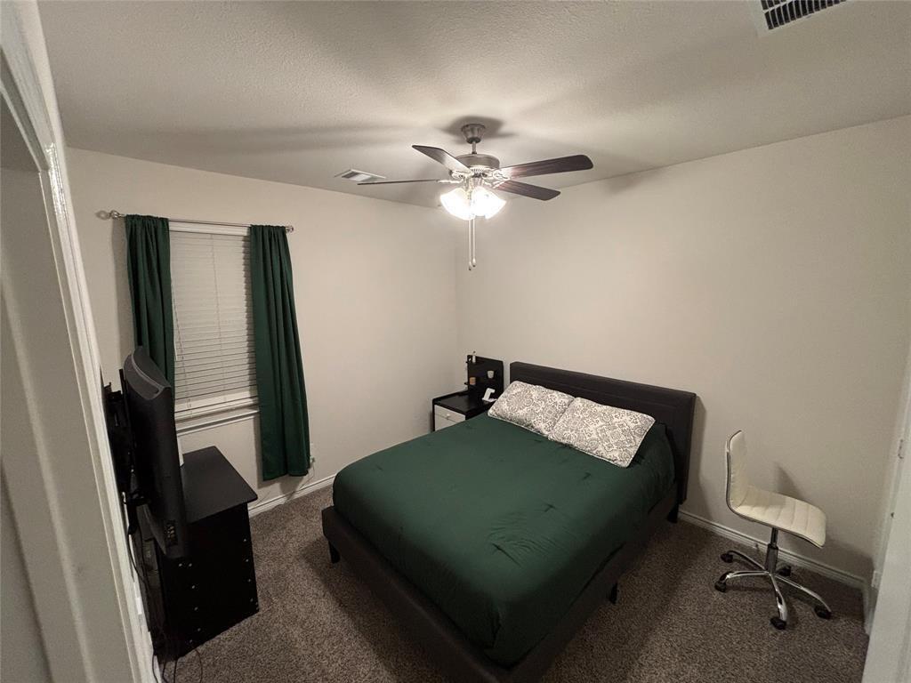 10512 Autumn Leaves Lane Aubrey, TX 76227 - Photo 8 of 9 a bedroom with a bed and a chandelier