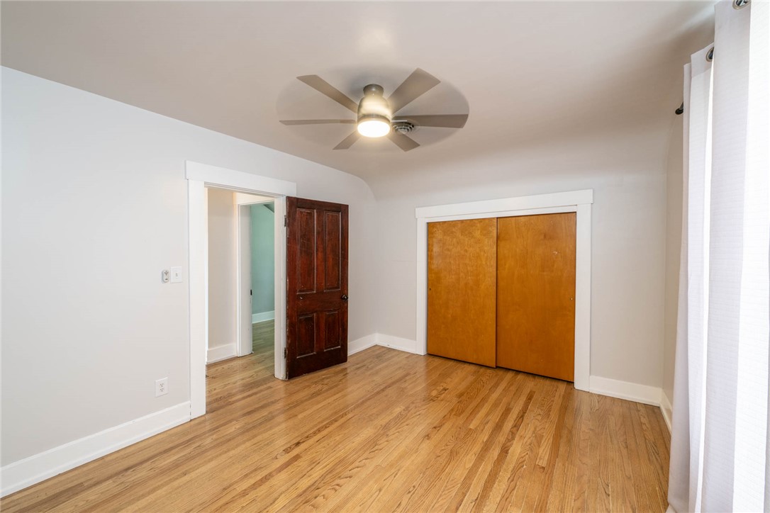 190 Swailes Road Troy, OH 45373 - Photo 12 of 82 This inviting bedroom features rich hardwood flooring and a functional closet for optimal living.