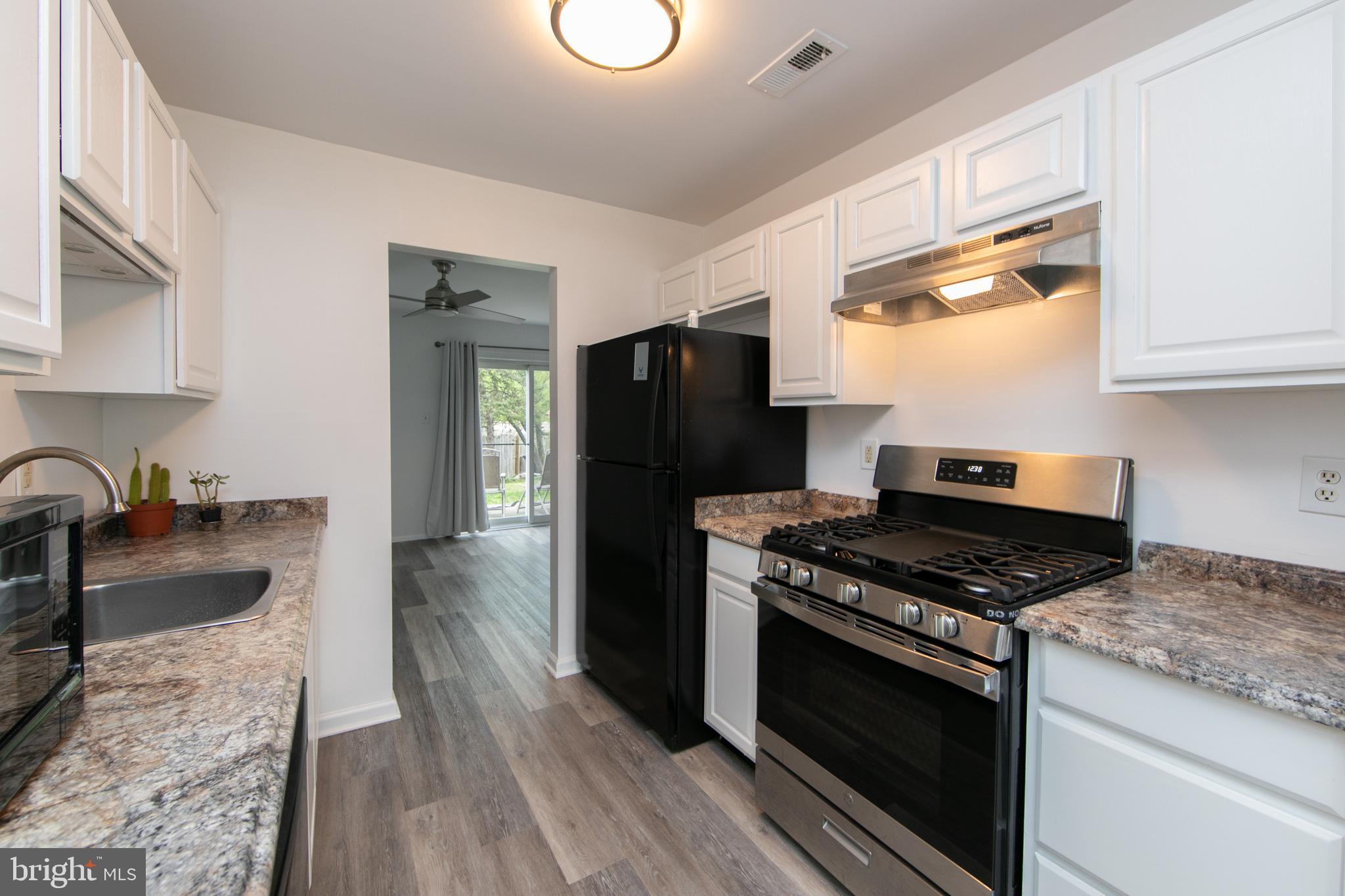 5401 Red Haven Drive Evesham, NJ 08053 - Photo 11 of 35 a kitchen with granite countertop stainless steel appliances a stove a refrigerator a sink a counter space and cabinets