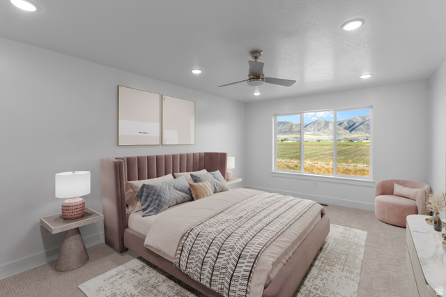 257 West 2950th Street South Logan, UT 84321 - Photo 11 of 11 Spacious primary bedroom featuring a tufted upholstered headboard in mauve, recessed ceiling lighting, and a ceiling fan