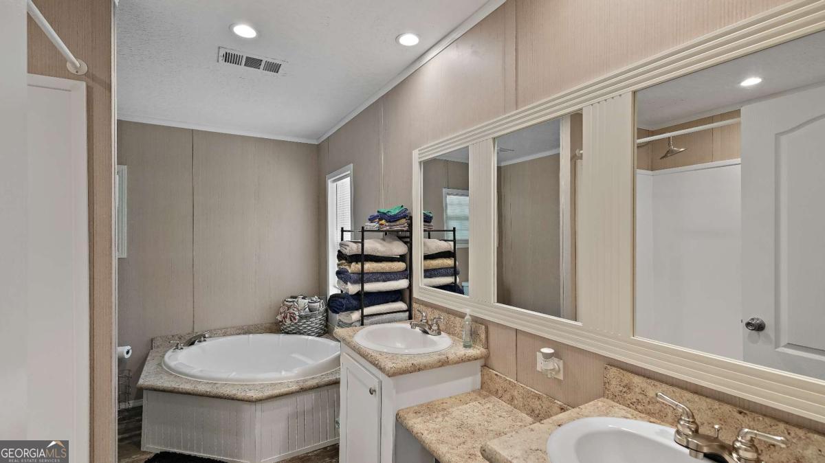 64 Sierra Road Jesup, GA 31545 - Photo 19 of 22 a bathroom with a toilet a sink and mirror