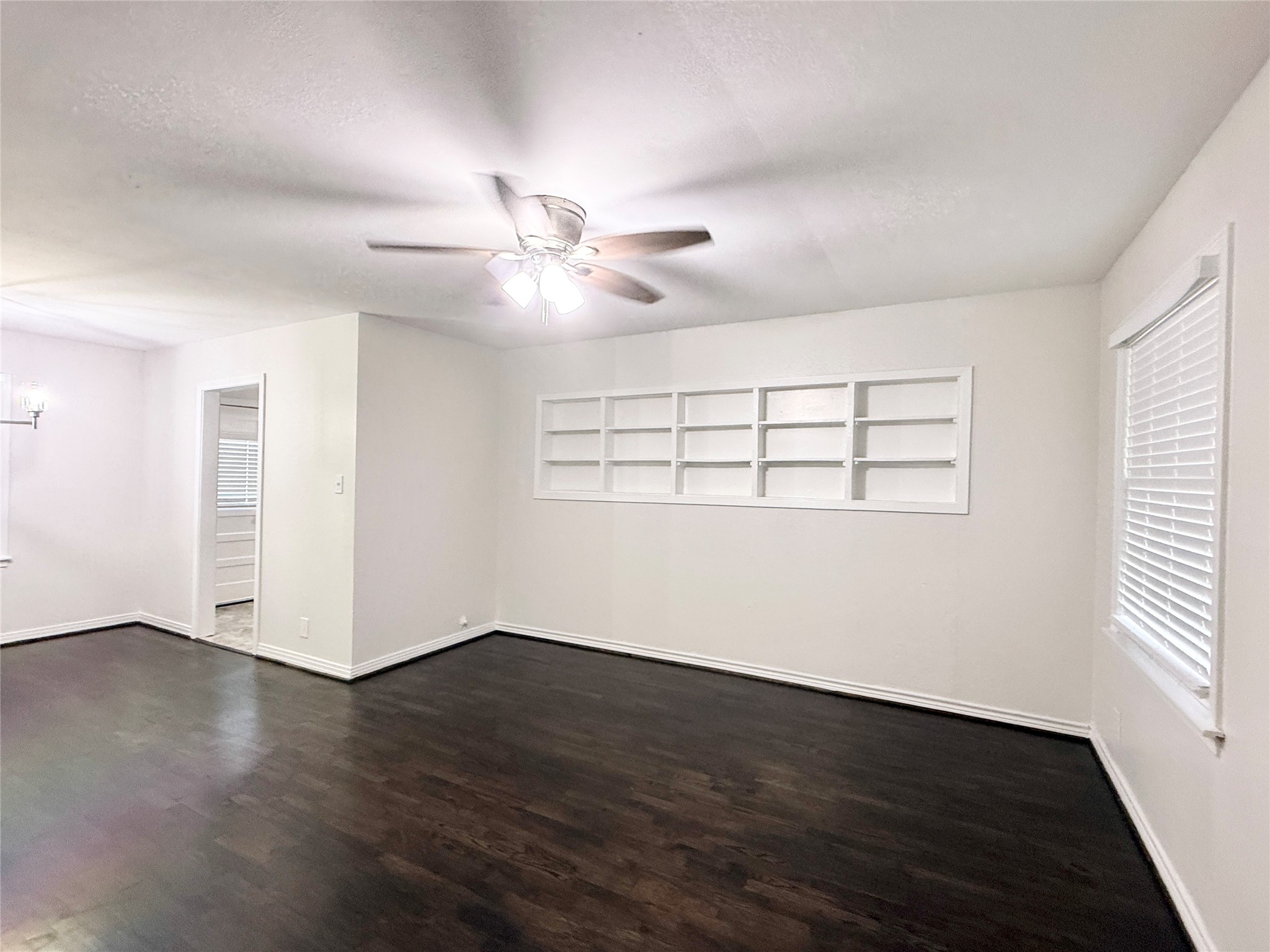 832 South Anderson Street Angleton, TX 77515 - Photo 5 of 19 a view of an empty room with wooden floor and a window
