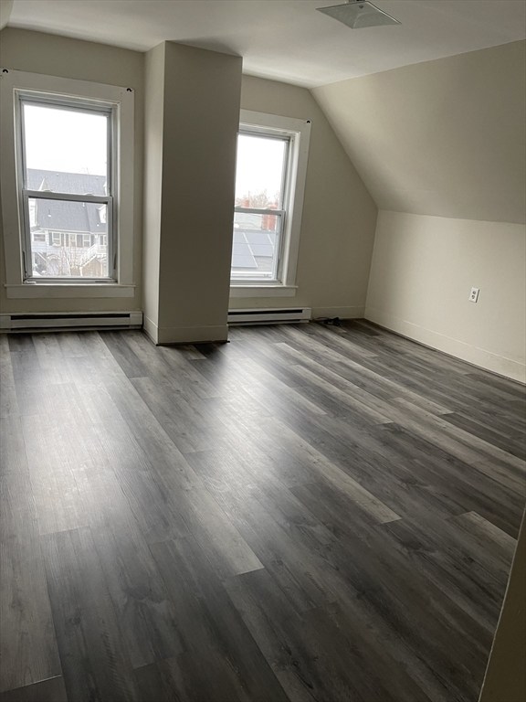 67-69 Loring Street Lowell, MA 01851 - Photo 11 of 16 an empty room with wooden floor and windows