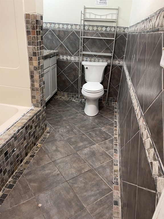 67-69 Loring Street Lowell, MA 01851 - Photo 14 of 16 a bathroom with a toilet and a shower