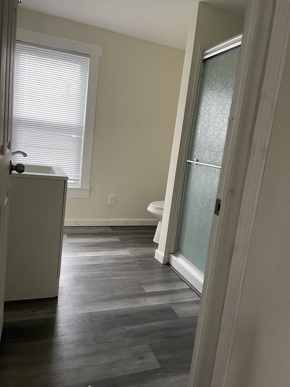67-69 Loring Street Lowell, MA 01851 - Photo 4 of 16 a view of an empty room with wooden floor and a window