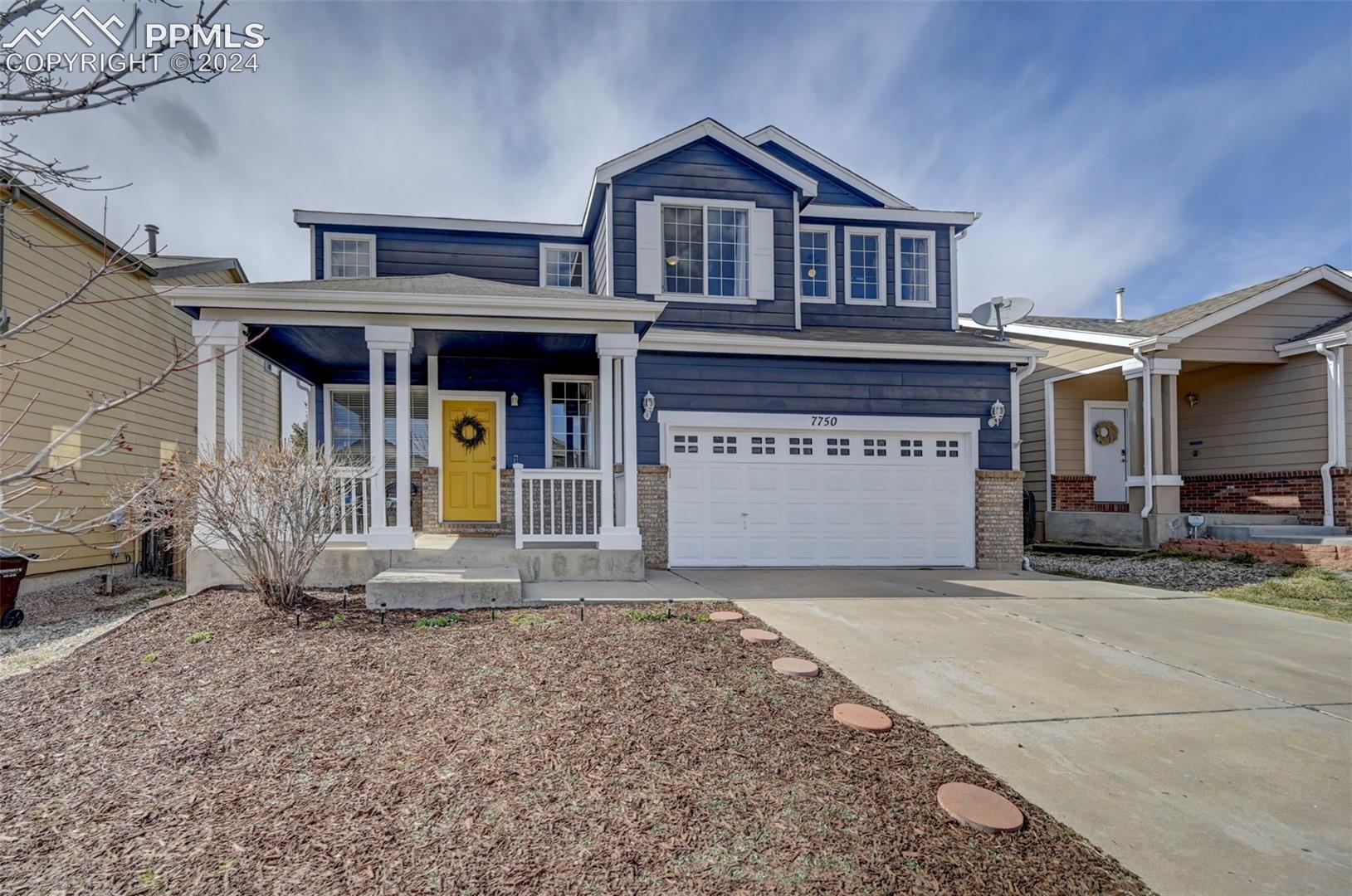7750 Old Spec Road Peyton, CO 80831 - Photo 1 of 9 View of front of property featuring covered porch and a garage