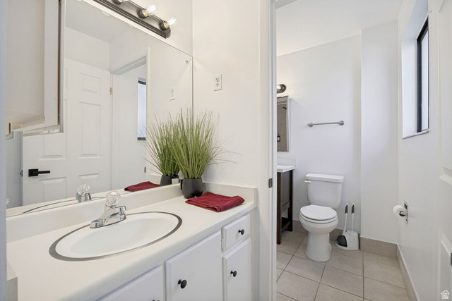 1723 Albury Road Sandy, UT 84092 - Photo 12 of 23 Bathroom vanity off primary bedroom featuring a white countertop with an integrated oval sink, chrome faucet, and white cabinetry with dark hardware