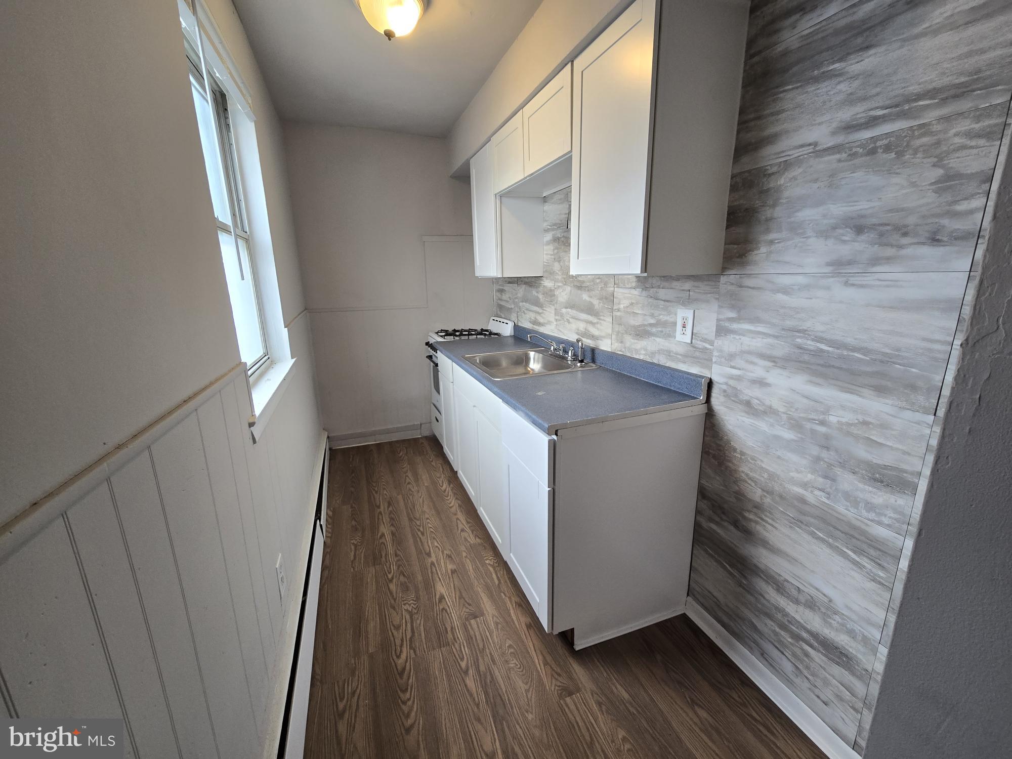 5302 Duffield Street Philadelphia, PA 19124 - Photo 3 of 12 a bathroom with a sink and a mirror