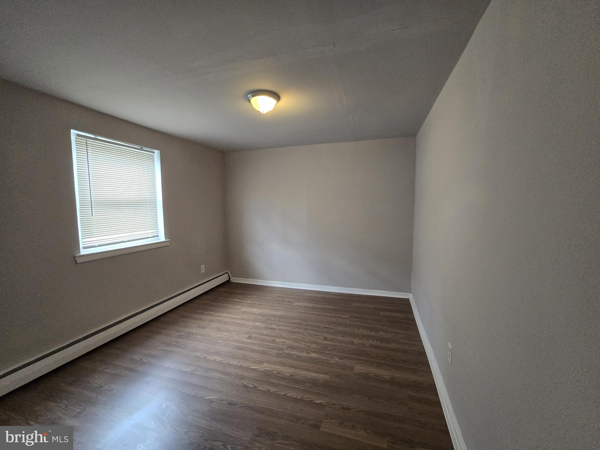 5302 Duffield Street Philadelphia, PA 19124 - Photo 7 of 12 an empty room with wooden floor and windows