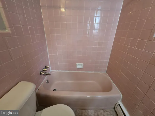 a bathroom with a bathtub and toilet