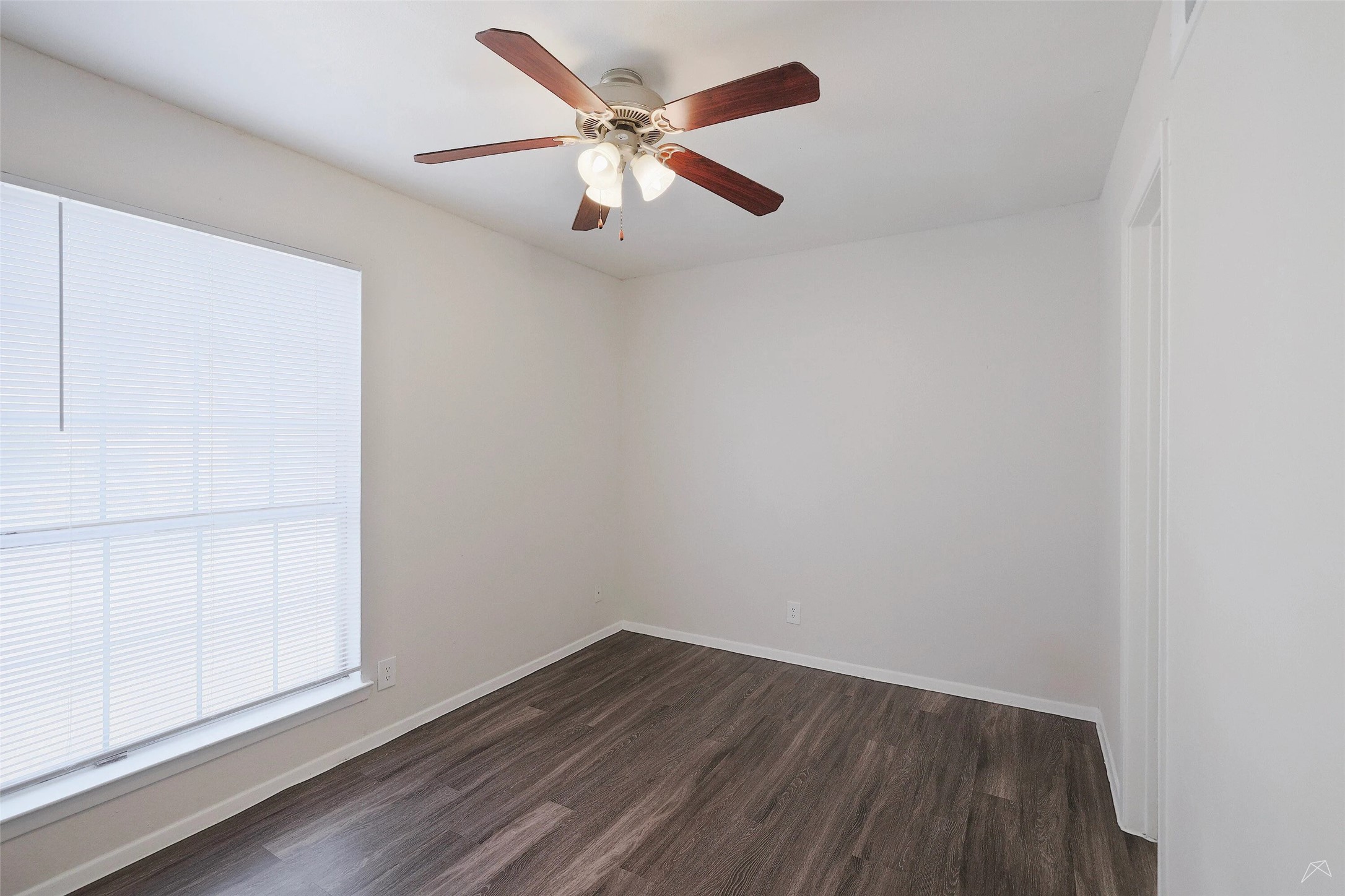 6808 South I-35 Frontage Road, Unit 253 Austin, TX 78745 - Photo 15 of 21 Spare room featuring dark wood finished floors and a ceiling fan