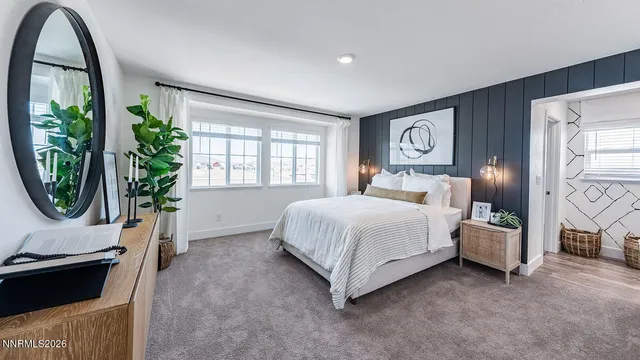 a bedroom with a bed a mirror and a window