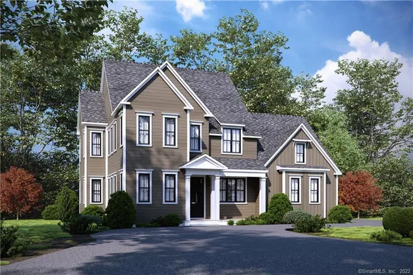 a front view of a house with a yard and trees