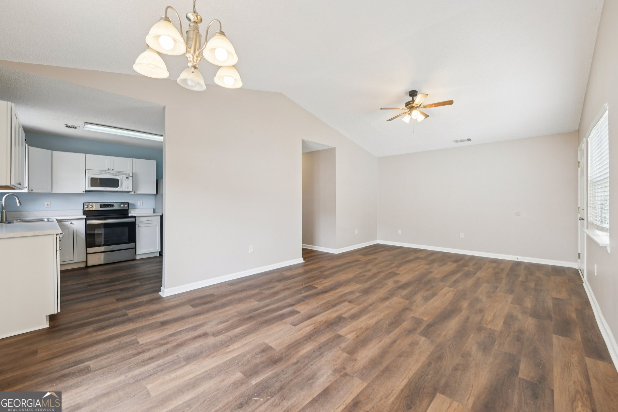 269 Buckingham Court Athens, GA 30607 - Photo 11 of 35 a view of empty room with wooden floor and kitchen view