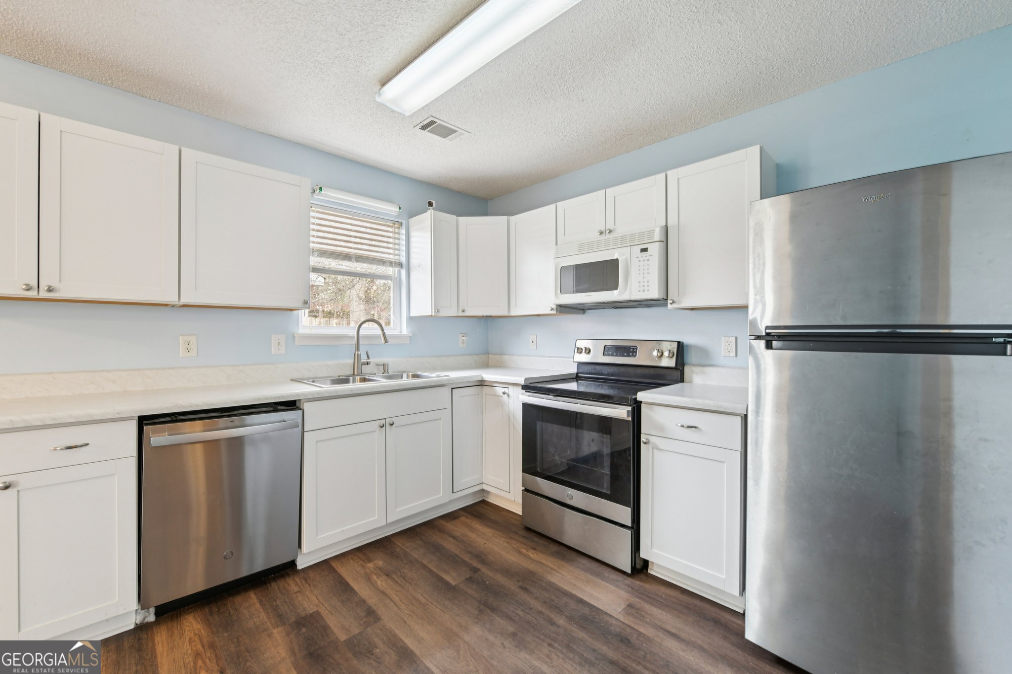 269 Buckingham Court Athens, GA 30607 - Photo 15 of 35 a kitchen with granite countertop white cabinets and white appliances