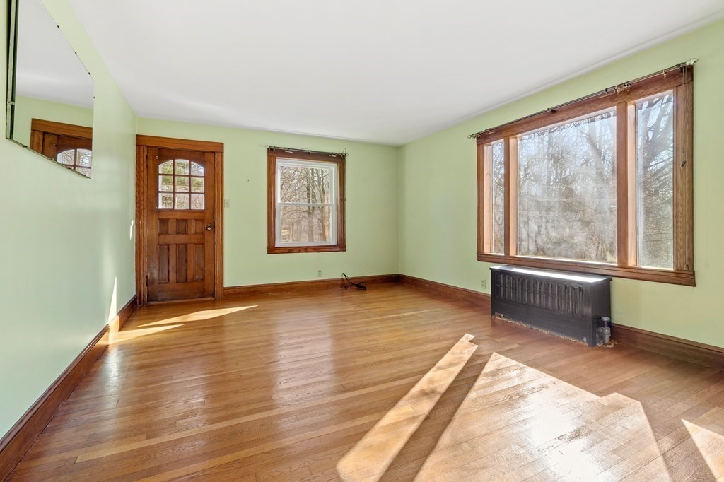 13 Dearborn Road Methuen, MA 01844 - Photo 16 of 39 a view of an empty room with a window and wooden floor