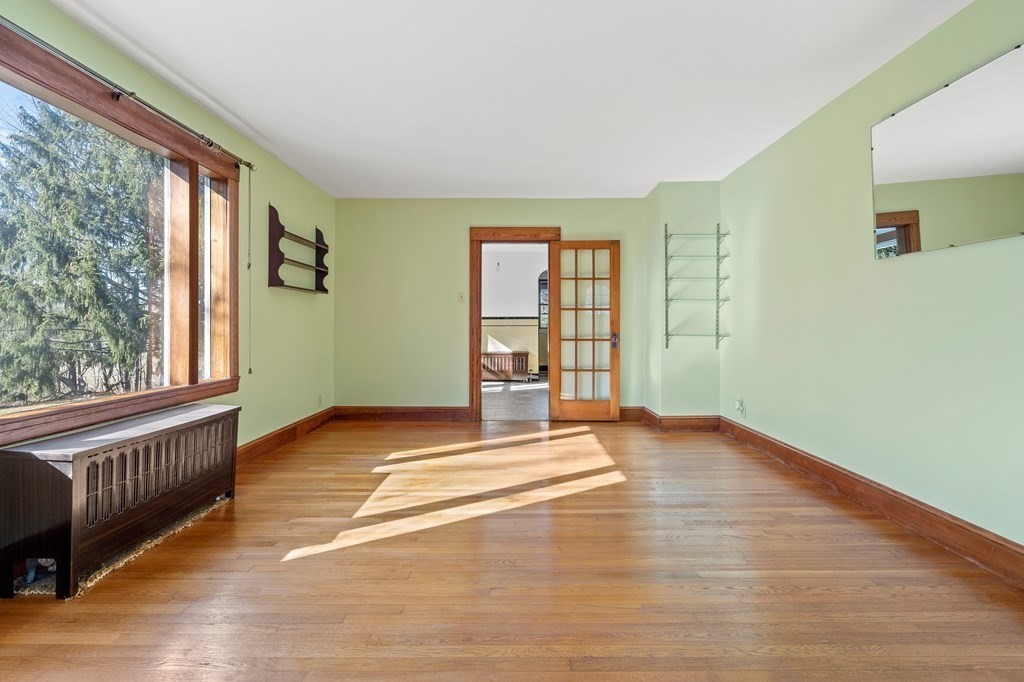 13 Dearborn Road Methuen, MA 01844 - Photo 17 of 39 a view of an empty room with a window and wooden floor