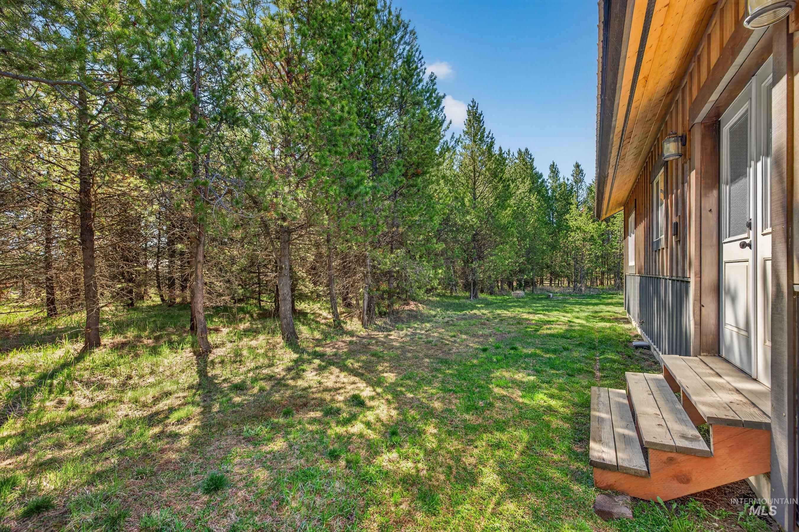 13388 Norwood Road McCall, ID 83638 - Photo 21 of 44 Exterior wood-paneled siding and a natural wood-finish porch with steps