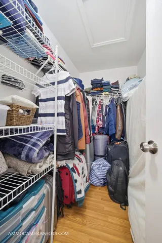 a view of walk in closet with clothes and shoes