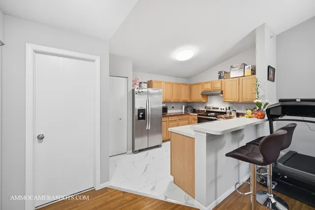 a kitchen with a refrigerator a stove and a sink