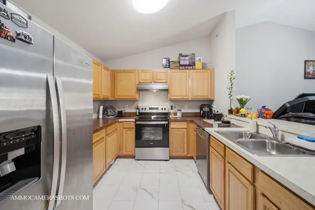 a kitchen with a sink stove and refrigerator