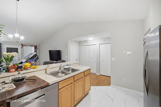a kitchen with a sink refrigerator and microwave