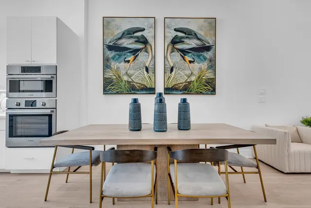 a living room with furniture and painting on the wall