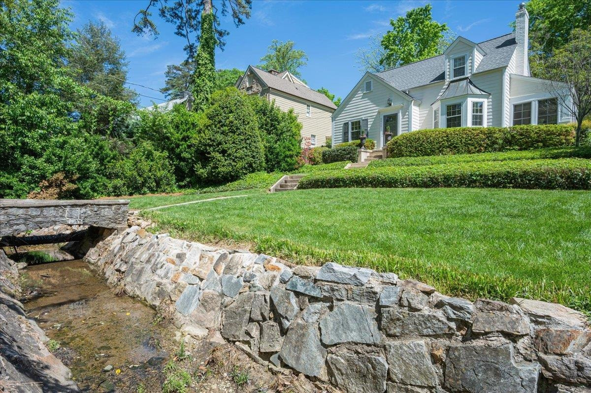 cross the stone surrounded bridge over enchanted brook to entry. Street parking and sidewalks to stroll in addition to 1 car detached garage access from alley way. Facade/Exterior Front