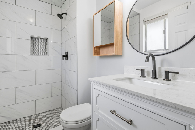 2693 Teal Way Sandy, UT 84093 - Photo 12 of 50 Bathroom featuring a white vanity with a stone-finish countertop, undermount sink, and matte black fixtures
