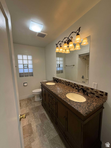 73 Garden Street Helper, UT 84526 - Photo 26 of 36 Bathroom featuring double vanity and stone finish flooring