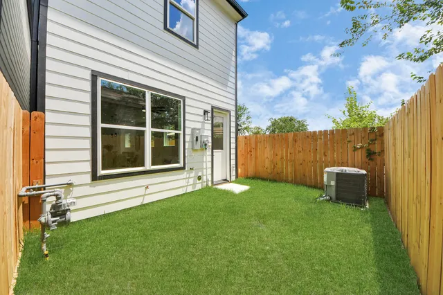 a view of a backyard with a garden and entertaining space