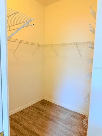 a view of a room with wooden floor