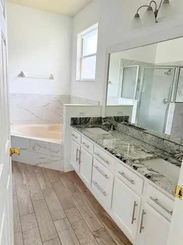 a bathroom with a granite countertop sink a toilet and bathtub