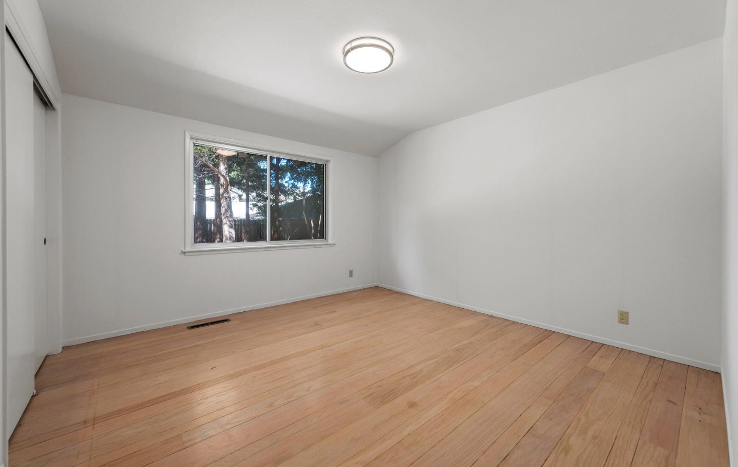 2 Lowery Drive Atherton, CA 94027 - Photo 20 of 32 an empty room with wooden floor and windows