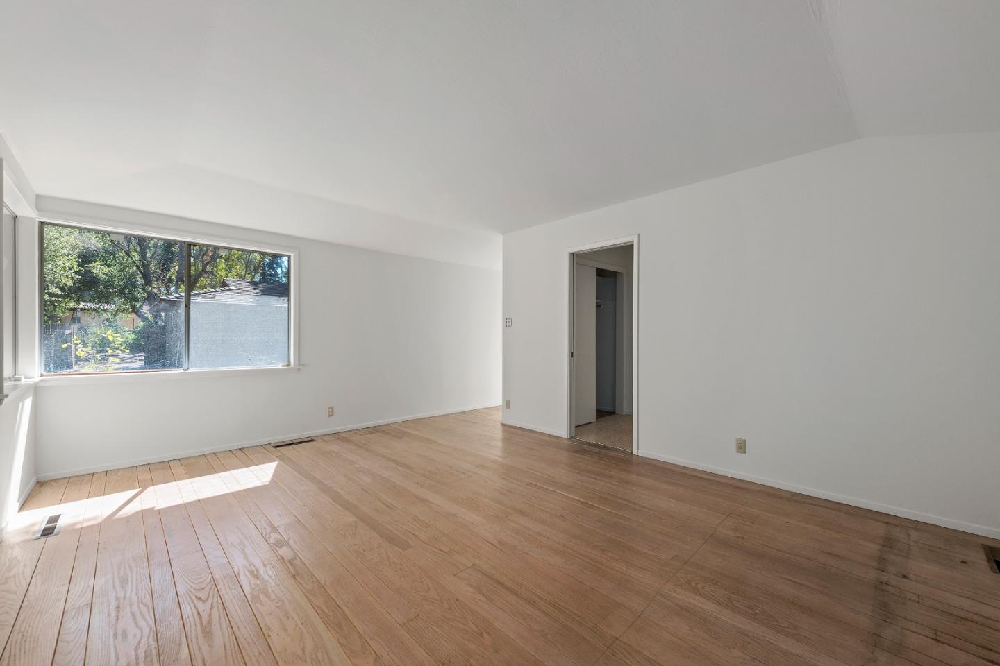 2 Lowery Drive Atherton, CA 94027 - Photo 23 of 32 a view of an empty room with wooden floor and a window