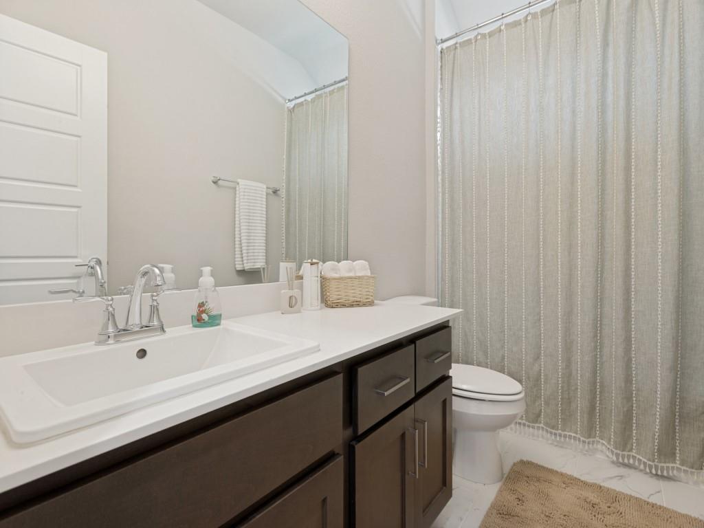 10613 Smiths Bnd Road Fort Worth, TX 76126 - Photo 18 of 29 Bathroom featuring a dark wood-finish vanity with a white countertop and an integrated rectangular sink