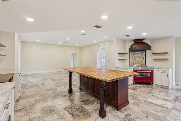 a kitchen with stainless steel appliances granite countertop a stove a refrigerator and a refrigerator