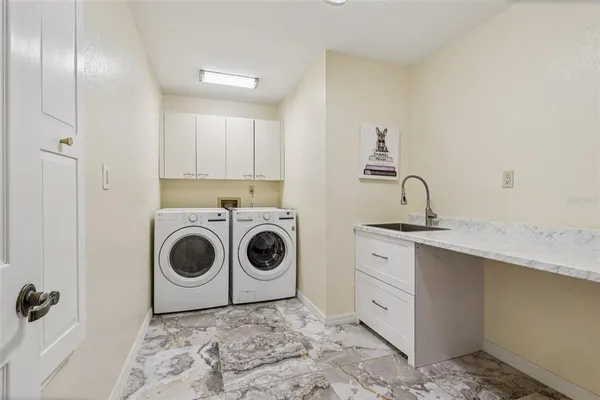 a kitchen with a stove top oven sink and cabinets