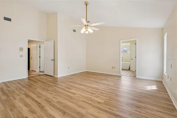 a view of empty room with wooden floor