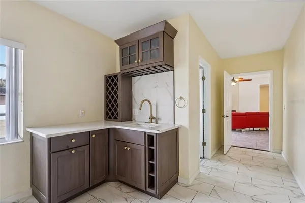 a view of kitchen with stainless steel appliances granite countertop a stove and a sink