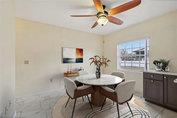 a dining room with furniture and window