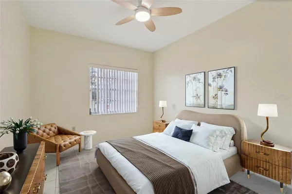 a bedroom with a bed and a chandelier