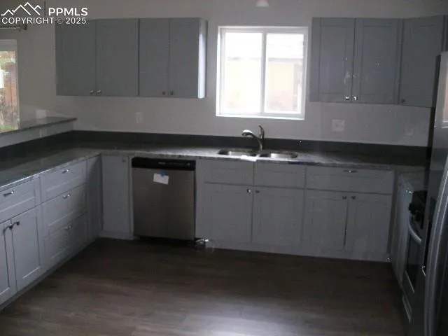 a kitchen with a sink cabinets and window