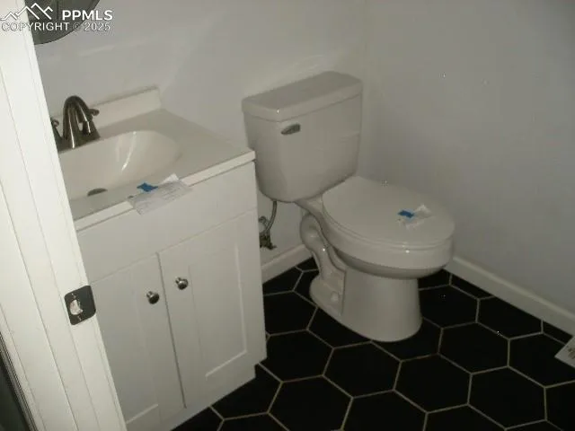 a bathroom with a sink toilet and a mirror