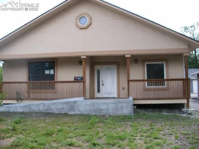 a view of backyard with a garden and deck
