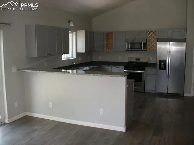 a kitchen with a sink a refrigerator freezer and a stove