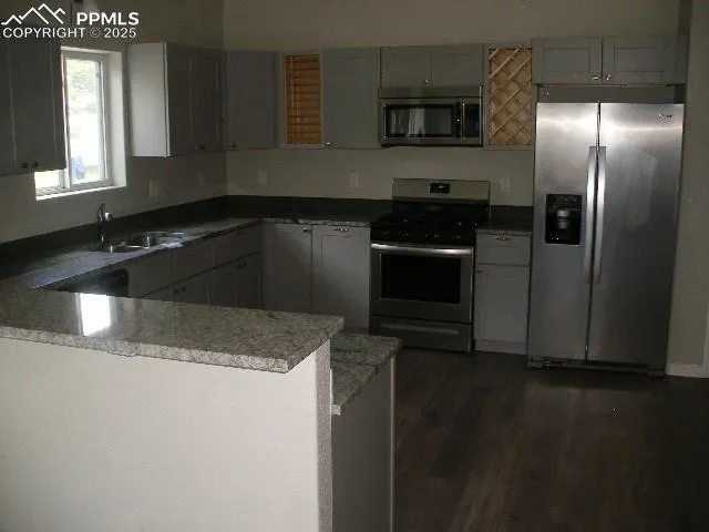 a kitchen with a sink and a refrigerator